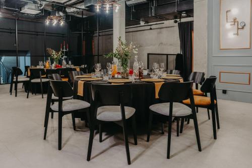 a group of tables and chairs in a room at Hotel M23 Katowice Centrum in Katowice