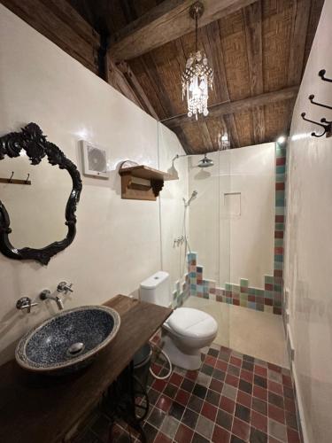 a bathroom with a sink and a toilet at Umakayu Joglo Villa Canggu - Boutique Hotel in Canggu