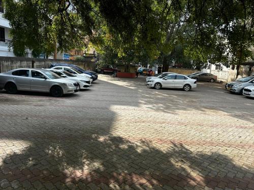 a group of cars parked in a parking lot at Hotel Grand Sabarees in Madurai
