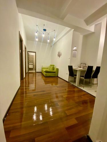 a living room with a green couch and a table at Charming Cozy 2br Ultracentral Old Town in Bucharest