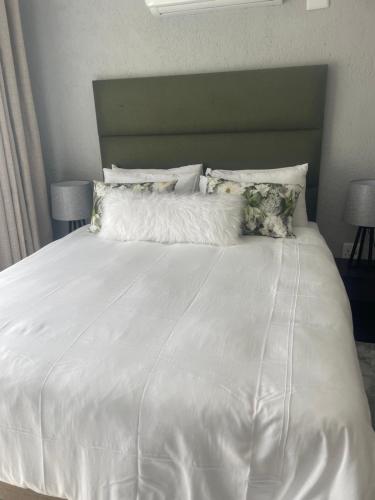 a white bed with white sheets and pillows at Masana at Homely Escape in Phalaborwa