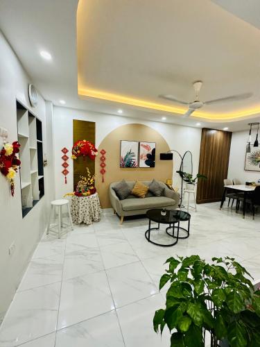 a living room with a couch and a table at NalSol House in Hanoi