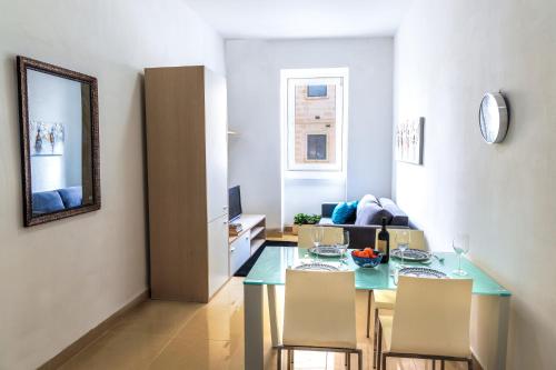 a living room with a table and a couch at Stylish St Julians 2 bedroom apartment for rent in the city centre with Terrace in St. Julianʼs