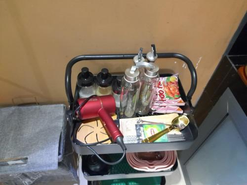 a shelf with utensils and other items on it at Nhà Yên 1 Bed 2 Beds Hotel Homestay Hostel Cần Thơ in Can Tho