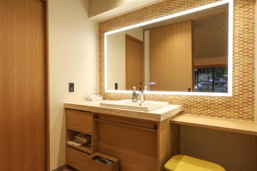 a bathroom with a sink and a mirror at SPA TERRACE Shisui in Kobe