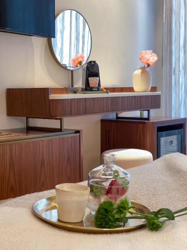 a tray with a bowl of food on a table at Jewel TLV Hotel in Tel Aviv