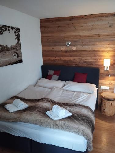 a bedroom with two beds with towels on them at Appartement Paulina Kaprun in Kaprun