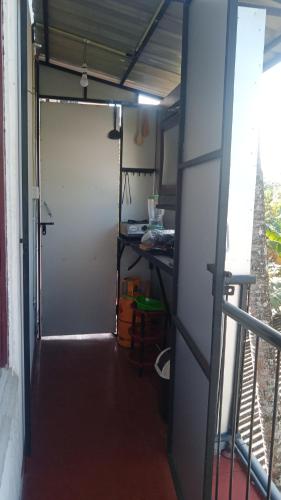 a garage with a door in a room at Little Swan Guest house in Bentota