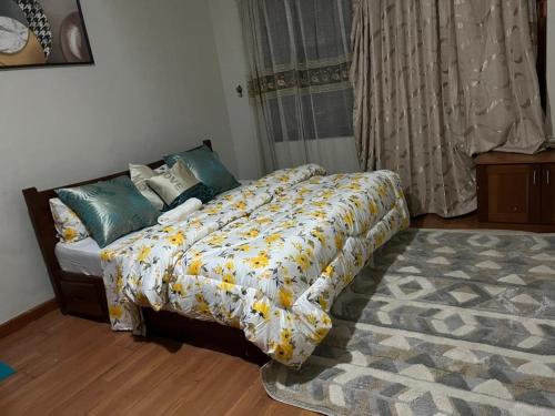 a bedroom with a bed and a rug at Rose house in Dar es Salaam