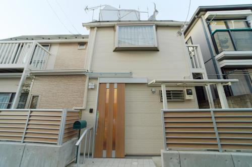 a house with a garage in front of it at Shinjuku 'Deep Lane' Villa in Tokyo