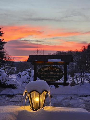 a light in the snow in front of a sign at Landhotel Halbfas-Alterauge in Drolshagen