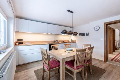 a kitchen with a table and chairs in a room at Chalet Hosp Reutte in Reutte
