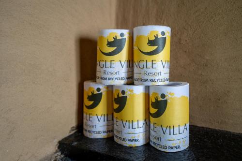 a stack of five cans of cuddle village will at Jungle Villa Resort - Near Chitwan National Park in Chitwan
