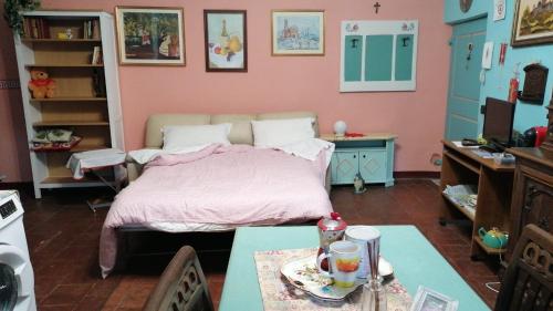 a bedroom with a bed and a table and a desk at “Corona Grossa” - due posti letto - A in Brusasco