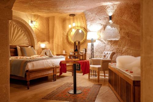 a bedroom with a bed and a mirror at Misty Cave Hotel in Urgup