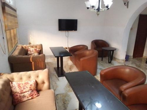 a living room with leather furniture and a table at Light house hotel in Lekki