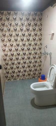 a bathroom with a toilet and a shower at Vattavada Jungle Resort in Munnar