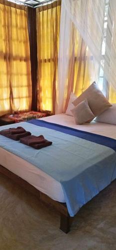 a bedroom with a bed with a canopy at Phayam Valley Homestay in Ko Phayam