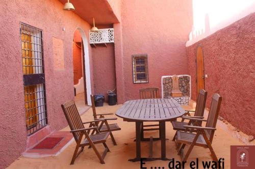 a patio with a table and chairs in a courtyard at DAR EL WAFI in Timimoun