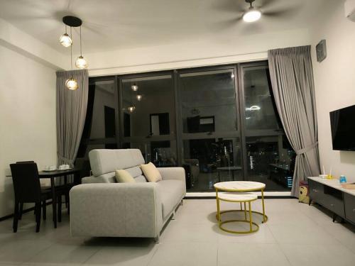 a living room with a couch and a table at Urban Suites, Best Seaview and Cityview in Town in Jelutong
