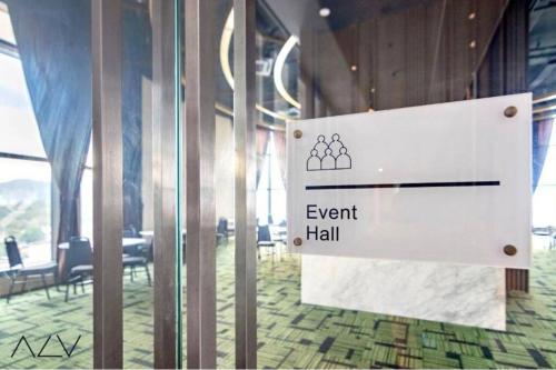 a sign in a room with a event hall at Urban Suites, Best Seaview and Cityview in Town in Jelutong