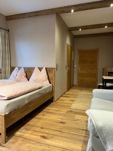 a bedroom with two beds and a wooden floor at Zimmer in Kirchberg in Tirol in Kirchberg in Tirol