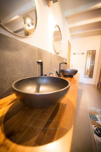 a bathroom with a large bowl sink on a counter at Maison Chez Jeannot in Saint-Geneys-près-Saint-Paulien