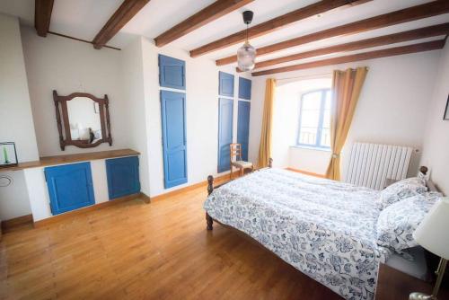 a bedroom with a bed and a mirror at Maison Chez Jeannot in Saint-Geneys-près-Saint-Paulien
