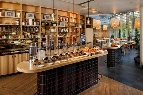 a restaurant with a counter with food on it at Palmiers by Fassbind in Lausanne
