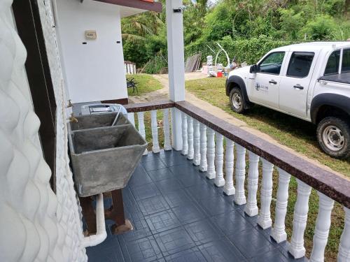 a white truck parked on the porch of a house at Olosara Haven in Nayawa