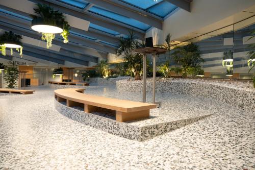 a lobby with a bench in the middle of it at Palmiers by Fassbind in Lausanne