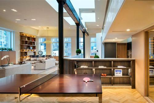 a living room with a table and a kitchen at Rasila SoHo in New York