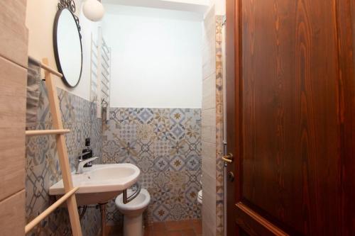 a bathroom with a sink and a mirror at La Locanda Di Giada in Pisa