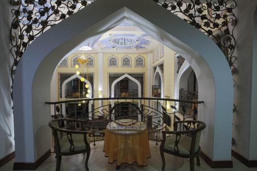a dining room with a table and chairs in a building at Zargaron Plaza in Bukhara