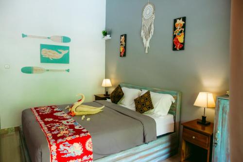a bedroom with a bed with a stuffed animal on it at Kinton Guesthouse in Nusa Penida