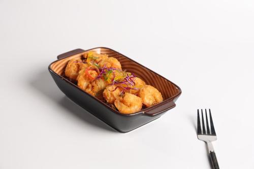 a tray of food with a fork next to it at شقق الماسة التاج للشقق الفندقية in Hail
