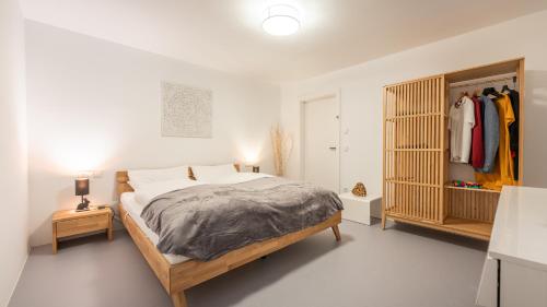 a bedroom with a large bed and a closet at Radochsbergloft in Abtenau