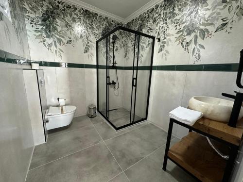 a bathroom with a shower and a sink at Kingway Suite in Nusratlı