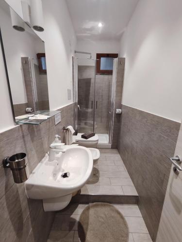 a bathroom with a toilet and a sink and a shower at Hotel Faraglione in Vulcano