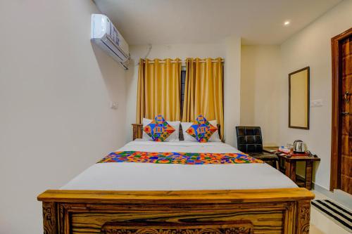 a bedroom with a large bed in a room at FabExpress Rithun Residency in Bangalore
