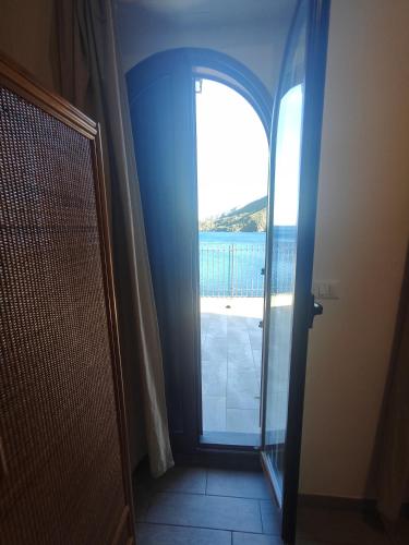 a door to a room with a view of the ocean at Hotel Faraglione in Vulcano