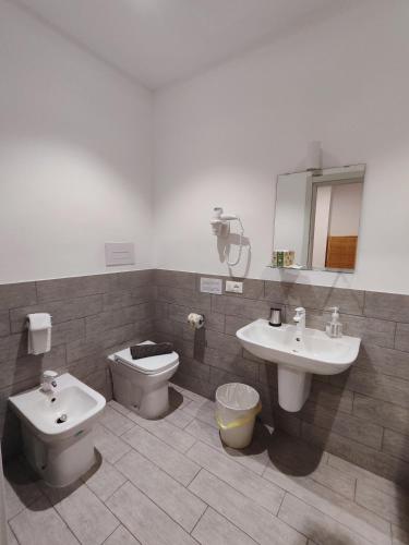 a bathroom with a toilet and a sink at Hotel Faraglione in Vulcano