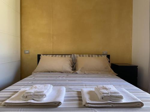 1 dormitorio con 1 cama con 2 toallas en Benaco Village Home, en Toscolano Maderno