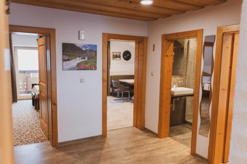 a hallway with two doors and a dining room at Gästehaus Annemarie in Kauns