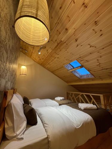 a bedroom with two beds and a chandelier at Berkri Gastro Yard & Guest House in Yenokavan