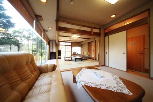 a living room with a couch and a table at Ryokan Ichinomatsu in Hakodate