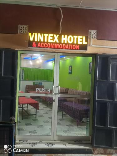 a glass door of a hotel with a sign on it at VINTEX GUEST HOUSE in Kimana