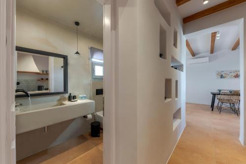 a bathroom with a sink and a mirror at Ambeli Sunset Villas in Megalokhori