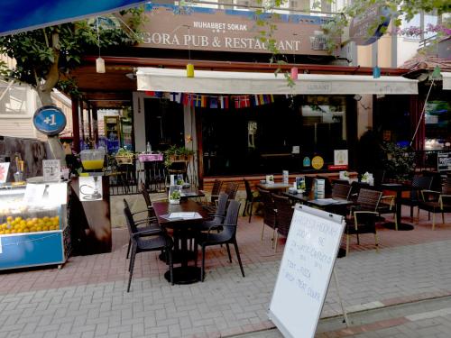an outdoor patio with tables and chairs and a restaurant at Agora Boutique Apart Hotel in Alanya