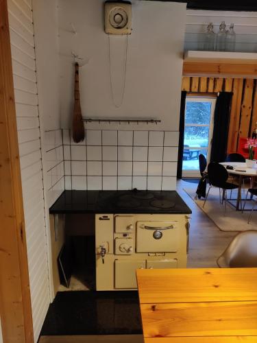 a small kitchen with a stove and a table at Amnerud 5 in Amnerud